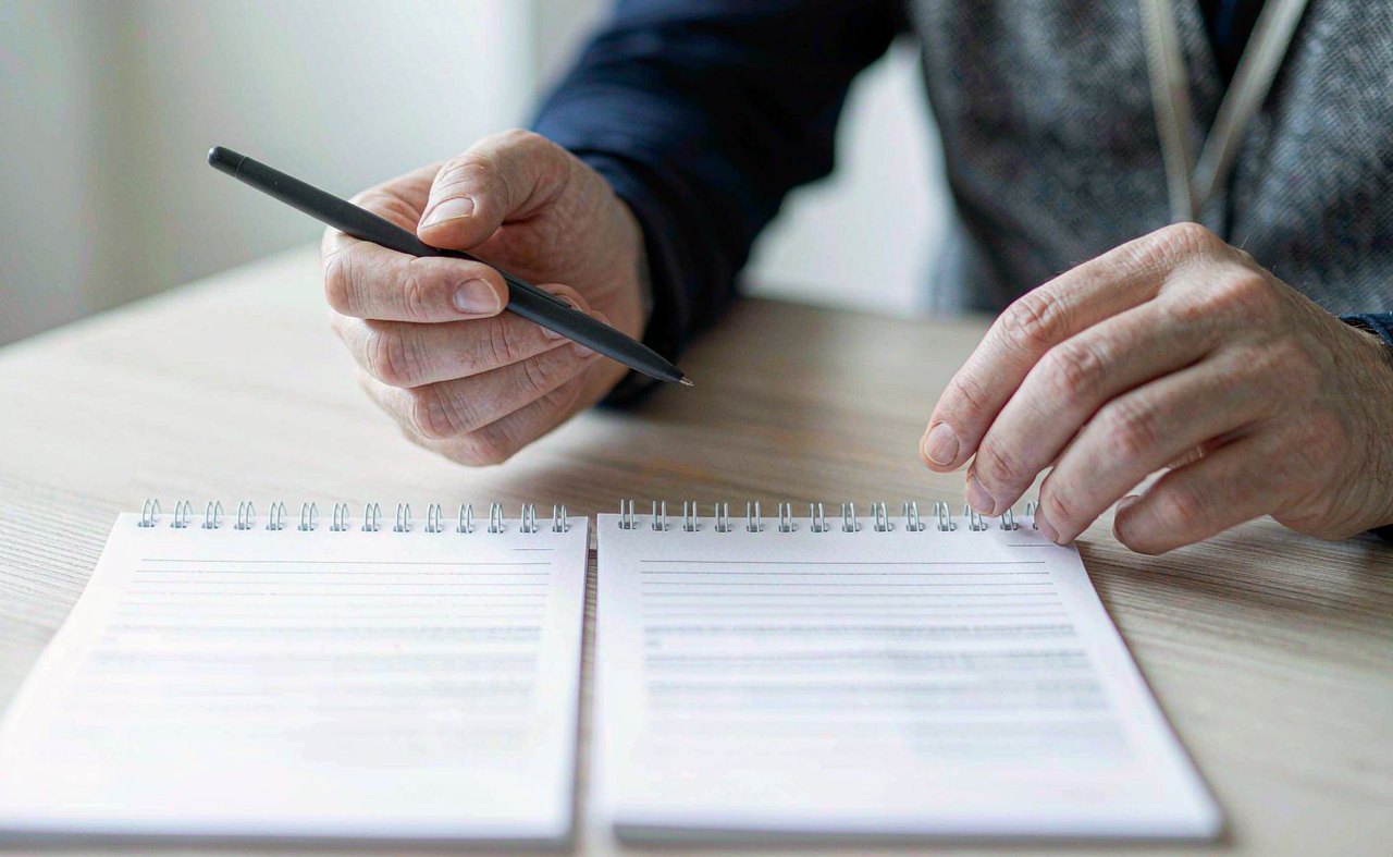 Two retirement plan enrollment forms side by side on a wooden table